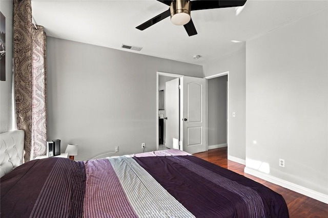 bedroom featuring baseboards, visible vents, ceiling fan, and wood finished floors