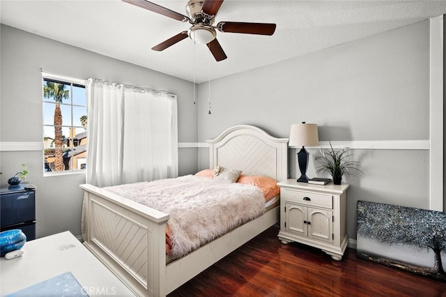 bedroom featuring ceiling fan and dark wood-type flooring