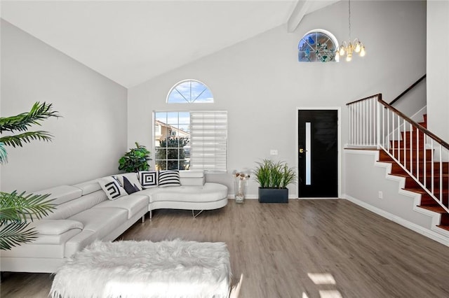 living area featuring wood finished floors, a chandelier, beamed ceiling, baseboards, and stairs