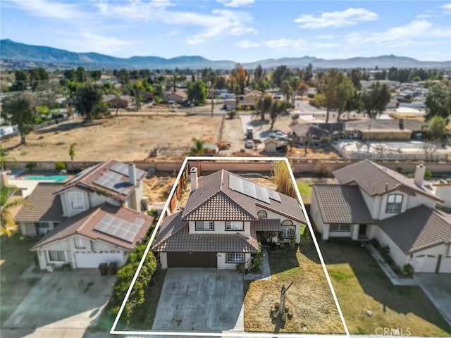 drone / aerial view featuring a residential view and a mountain view