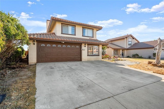 mediterranean / spanish home with a tile roof, driveway, a chimney, and stucco siding