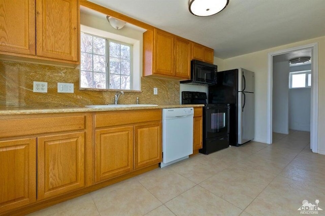 kitchen with sink, backsplash, and black appliances