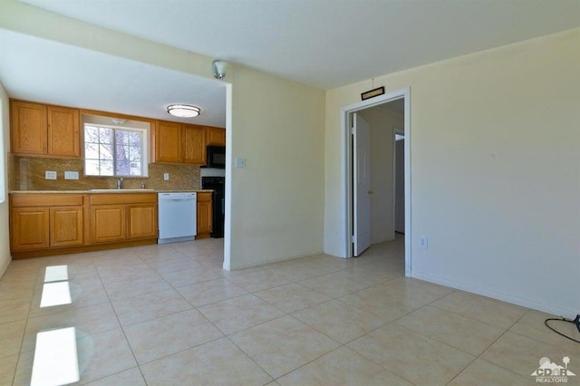 kitchen with light tile patterned floors, dishwasher, and tasteful backsplash