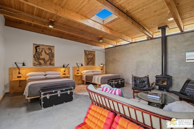 bedroom featuring a wall unit AC, concrete floors, rail lighting, and a wood stove