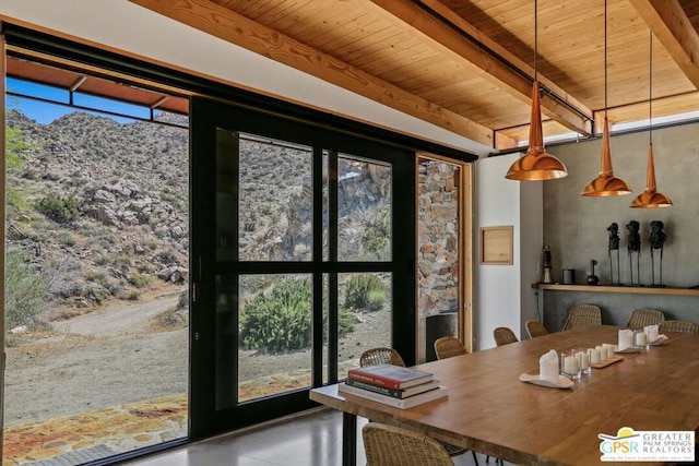 dining space with wooden ceiling, beam ceiling, and a healthy amount of sunlight