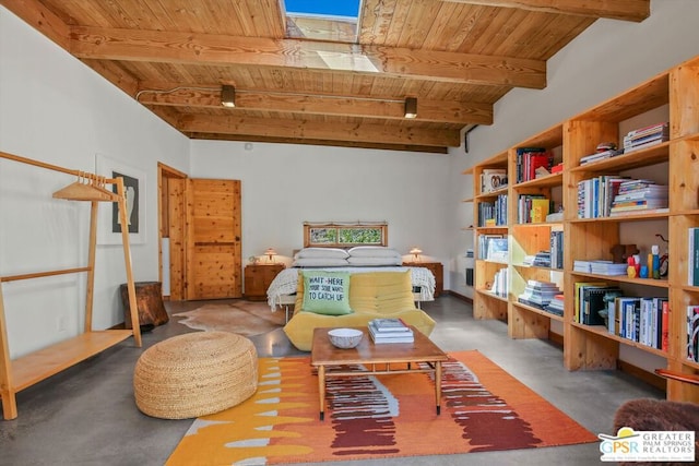 sitting room with beam ceiling, wood ceiling, and concrete flooring