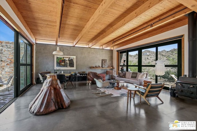 interior space featuring beam ceiling, wood ceiling, and concrete flooring