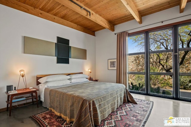 bedroom with concrete floors, wooden ceiling, beam ceiling, and rail lighting