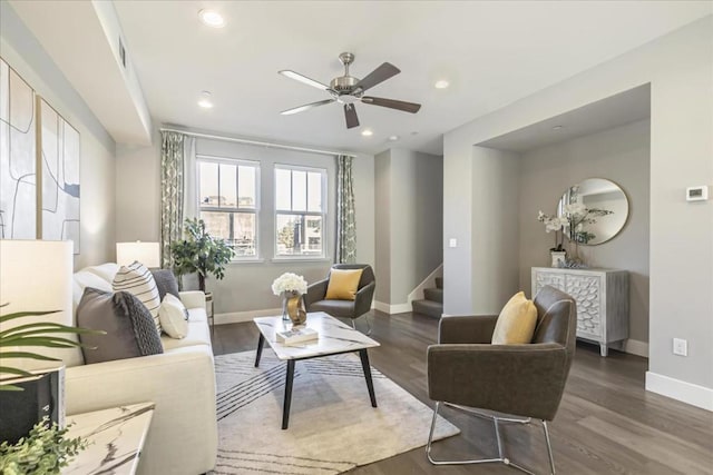 living area with ceiling fan and dark wood-type flooring