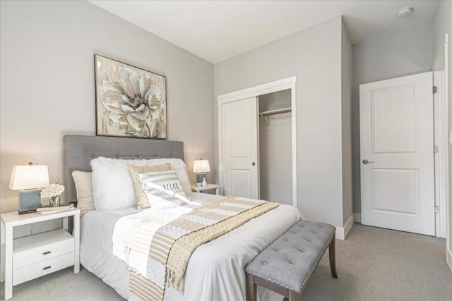 bedroom with a closet and light carpet