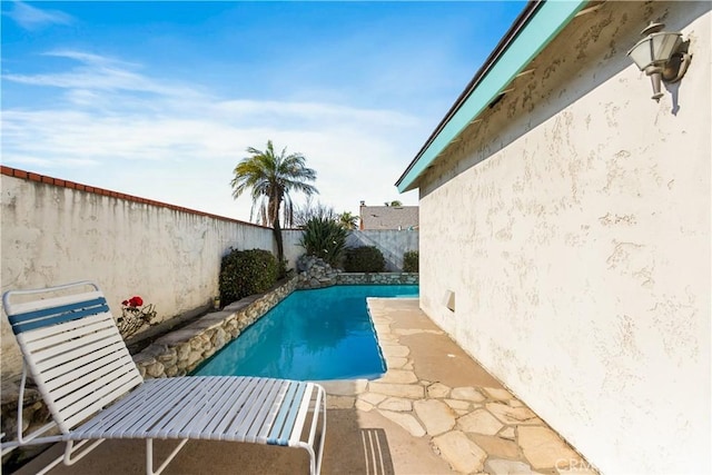 view of pool featuring a fenced in pool, a fenced backyard, and a patio