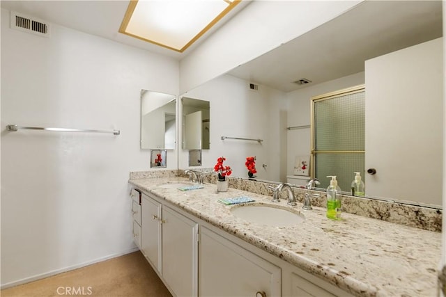 full bathroom with double vanity, visible vents, and a sink