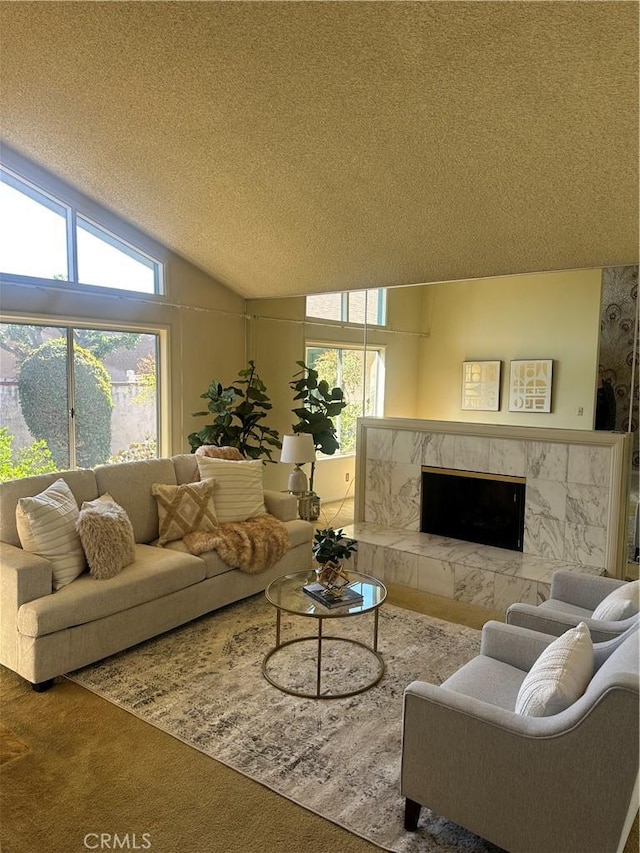 carpeted living room with vaulted ceiling, a premium fireplace, plenty of natural light, and a textured ceiling