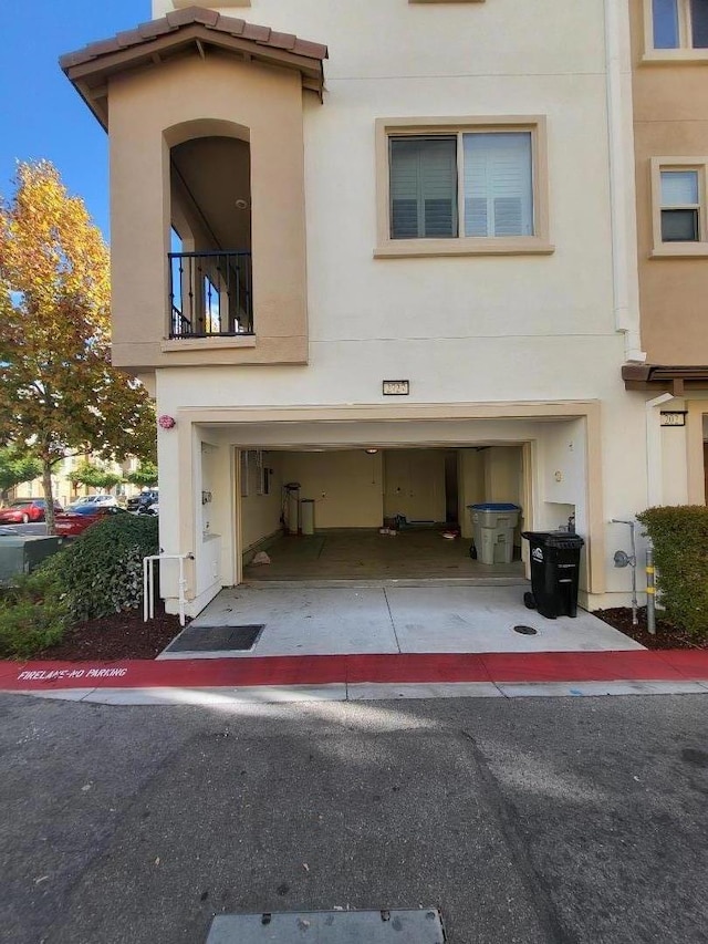 view of front of property with a balcony and a garage