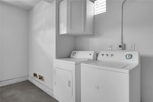 laundry room featuring washing machine and dryer and cabinets