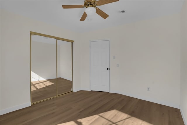 unfurnished bedroom with a closet, ceiling fan, and wood-type flooring