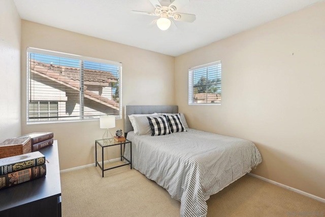 bedroom featuring ceiling fan and light carpet