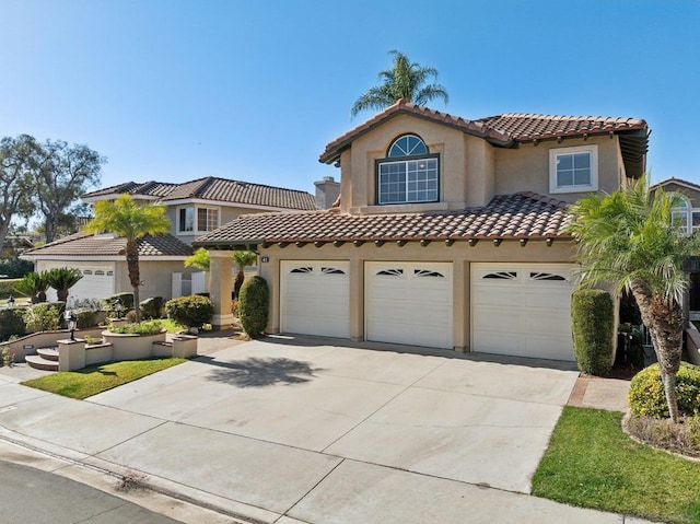 mediterranean / spanish house featuring a garage