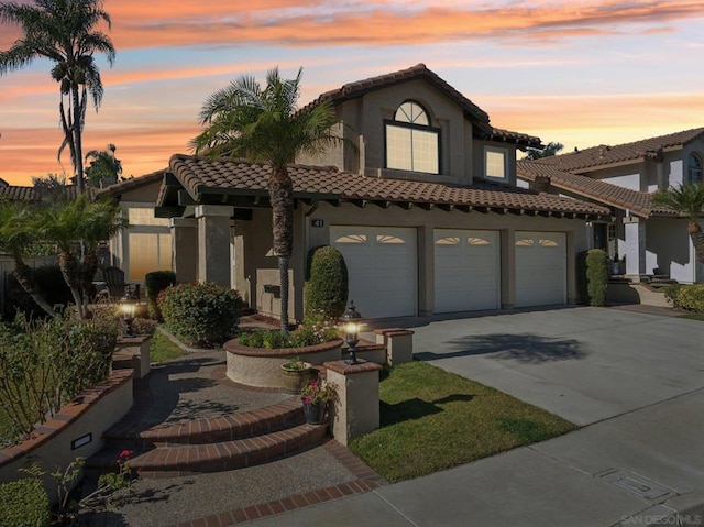 mediterranean / spanish-style house with a garage