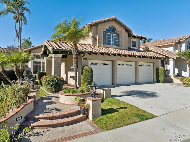 mediterranean / spanish home featuring a garage