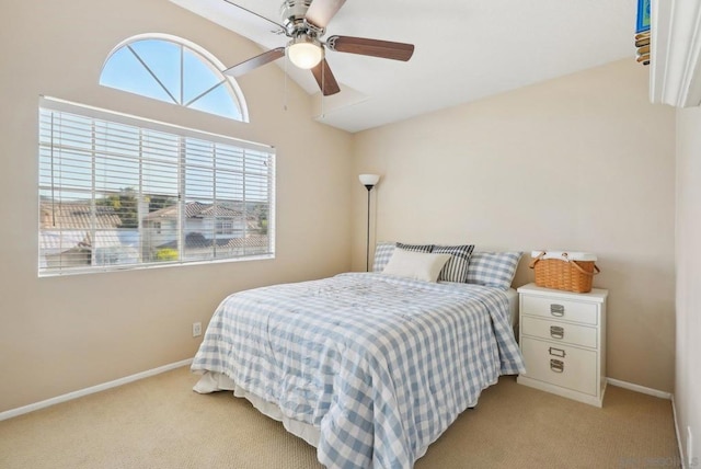 bedroom featuring lofted ceiling, ceiling fan, and light colored carpet