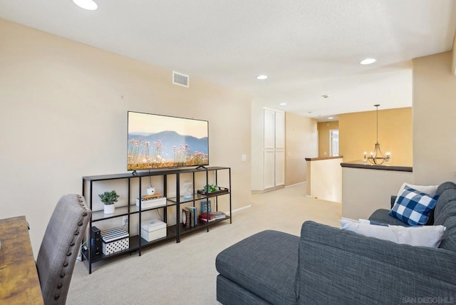 carpeted living room with a chandelier