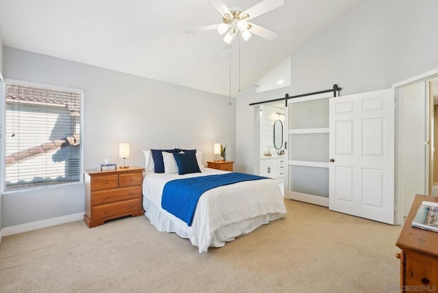 bedroom featuring ensuite bathroom, carpet flooring, ceiling fan, a barn door, and high vaulted ceiling