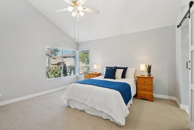 bedroom with a closet, a barn door, light colored carpet, ceiling fan, and high vaulted ceiling