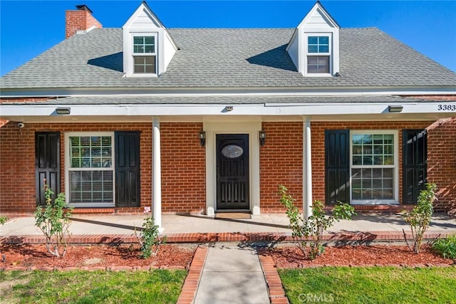 new england style home with a porch