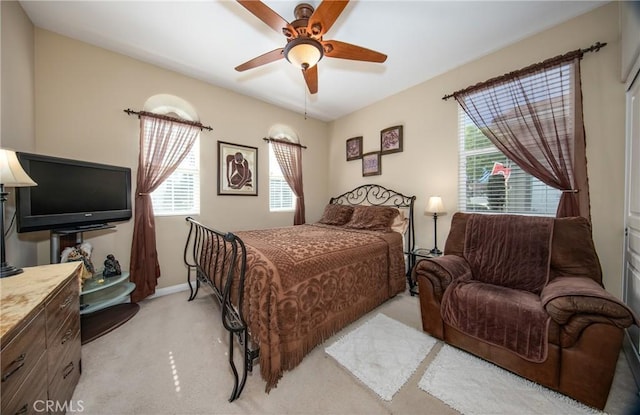 bedroom featuring ceiling fan and light colored carpet