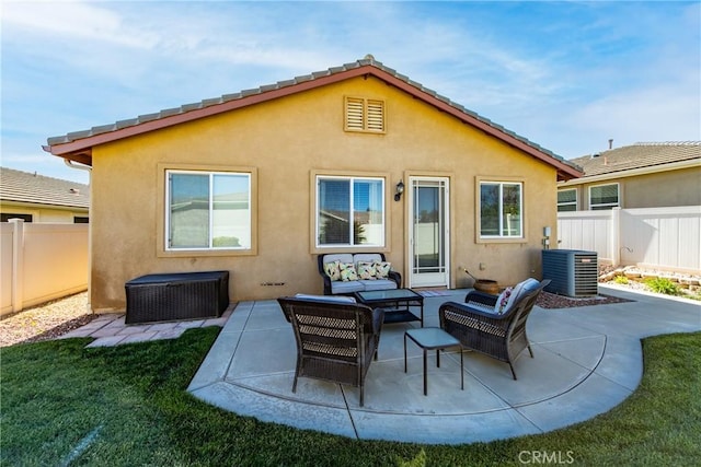 back of property with a patio, an outdoor hangout area, cooling unit, and a lawn