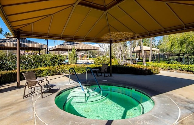 view of swimming pool with a gazebo, a patio, and a community hot tub