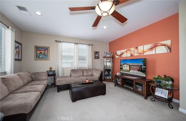 carpeted living room with ceiling fan