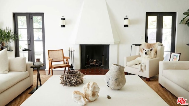 living room with a large fireplace and french doors