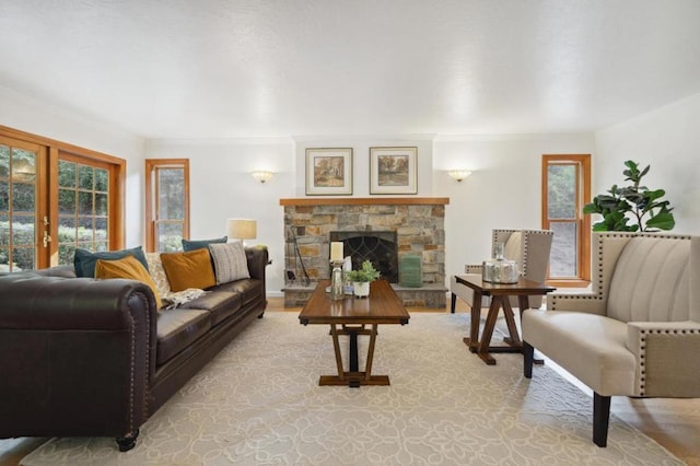 living room featuring french doors and a stone fireplace