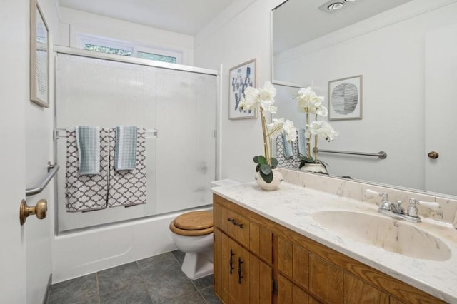 full bathroom featuring toilet, combined bath / shower with glass door, vanity, and ornamental molding