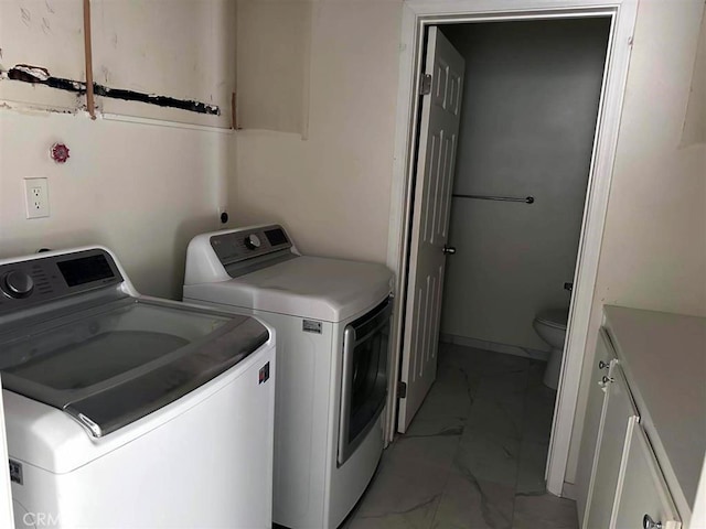 laundry room featuring cabinets and washing machine and clothes dryer