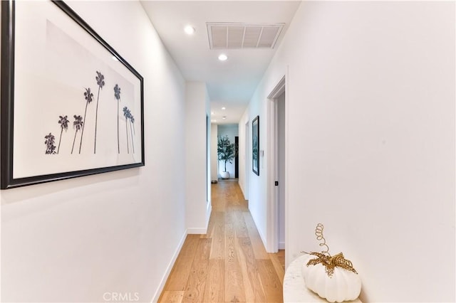 hallway with light hardwood / wood-style floors