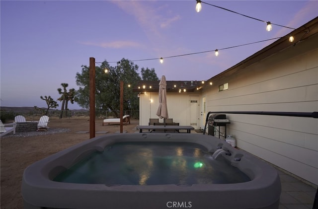 pool at dusk featuring a grill and a hot tub