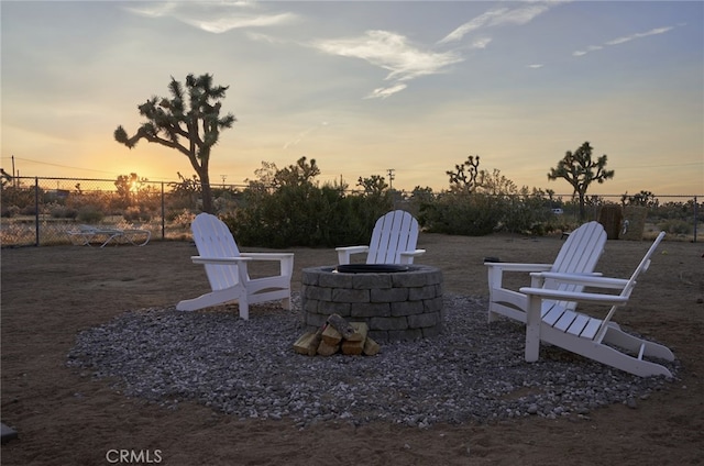 patio terrace at dusk featuring an outdoor fire pit