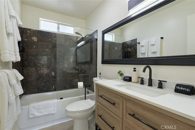 full bathroom with toilet, tiled shower / bath combo, and vanity