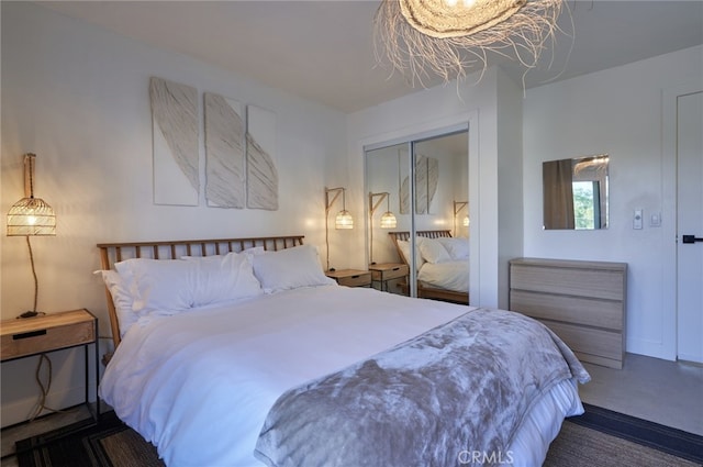 bedroom with a closet and dark colored carpet