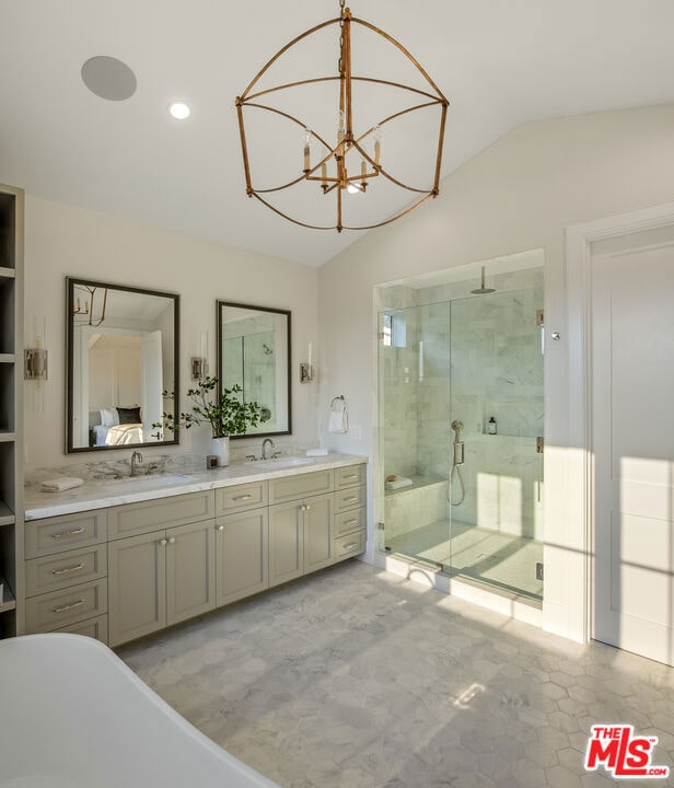 bathroom featuring lofted ceiling, separate shower and tub, a chandelier, and vanity