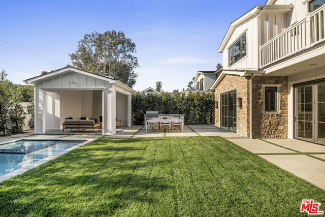 exterior space with an outdoor bar, an outdoor hangout area, an outdoor kitchen, a balcony, and a patio