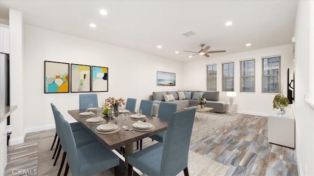 dining space with ceiling fan and hardwood / wood-style floors