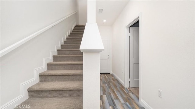 stairway featuring hardwood / wood-style floors