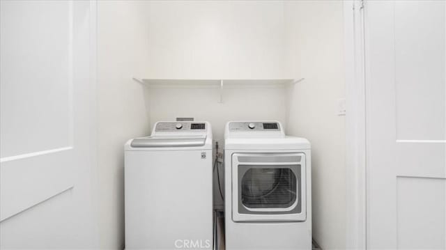 laundry room featuring washing machine and clothes dryer