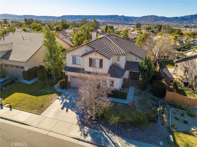 birds eye view of property with a mountain view