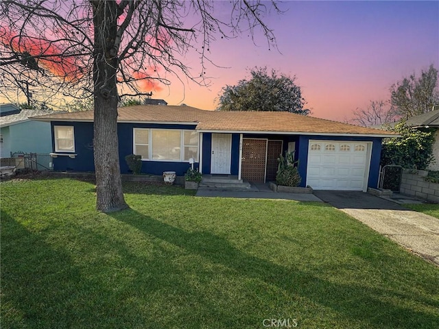 single story home with a lawn and a garage