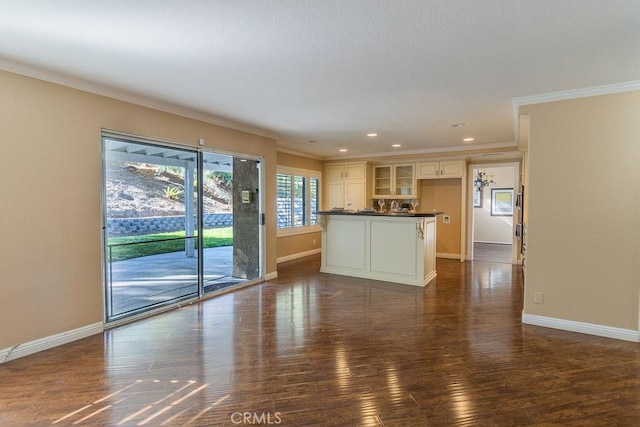 unfurnished living room with dark wood-type flooring and crown molding